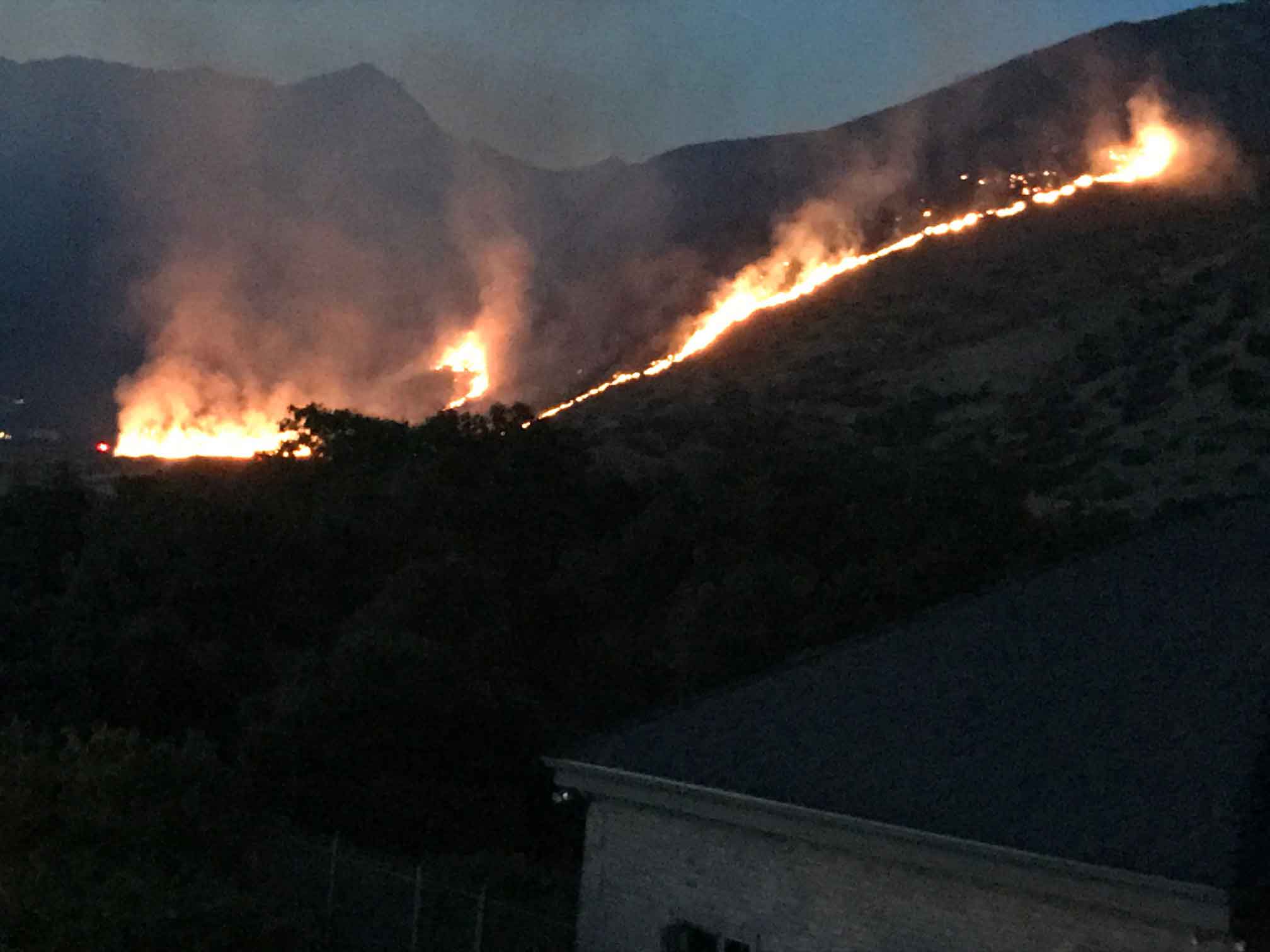 Wildfire burning up a mountainside