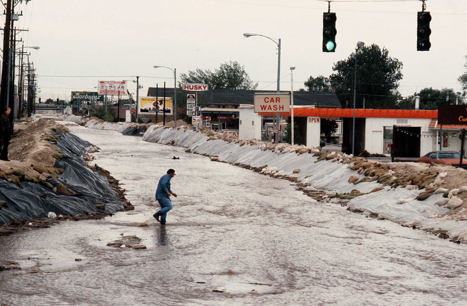 flooded streets with a person standing on the corner